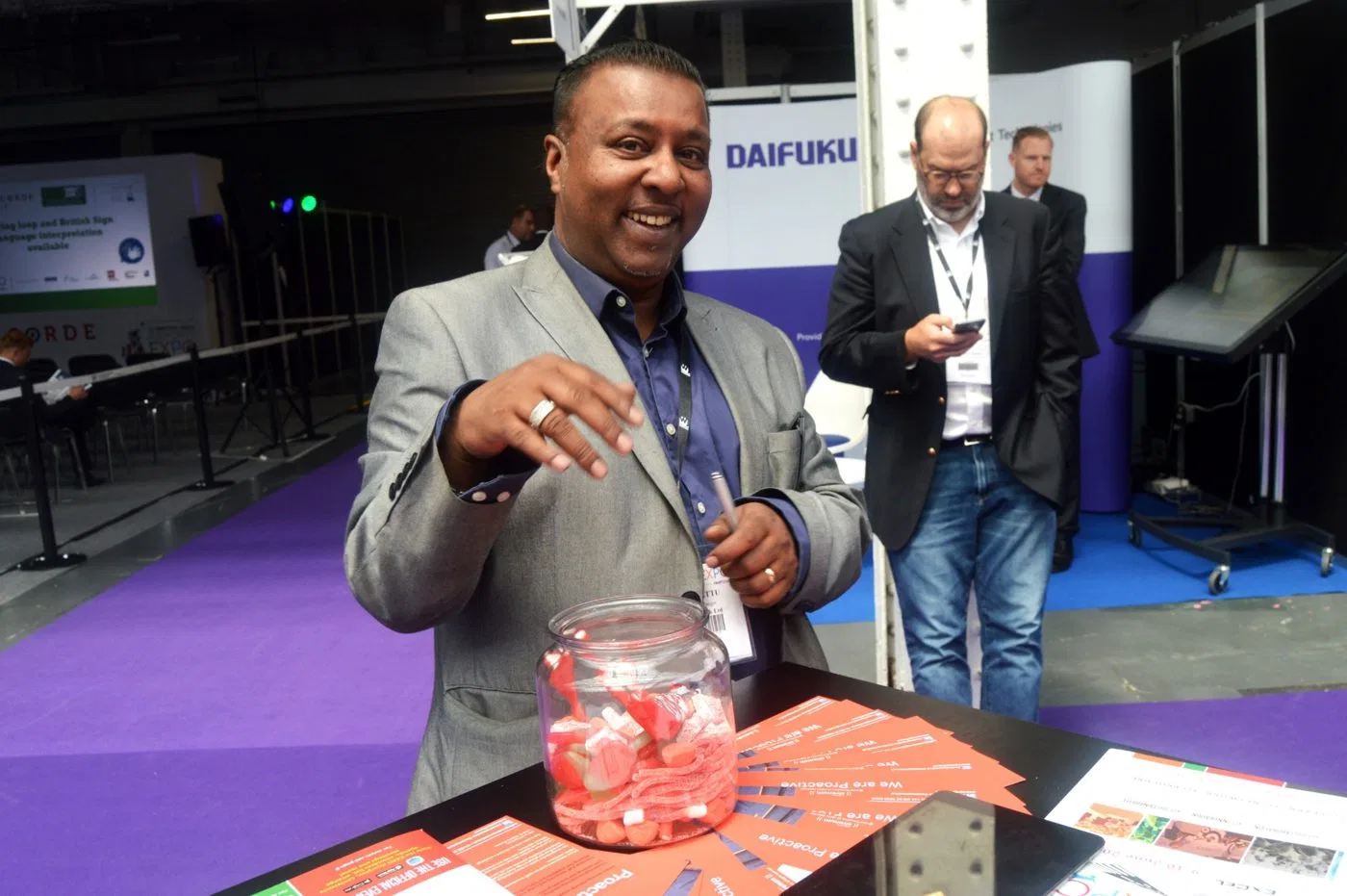 A visitor helping himself to sweets at the Proactive stand